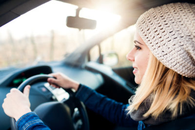 Woman driving a car to her appointment after Googling OBGYN near me | CU OB-GYN | Denver, CO