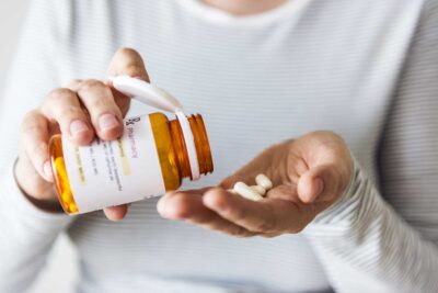 Woman with prescription drug bottle worrys about costs | CU OB-GYN | Denver & Aurora, CO