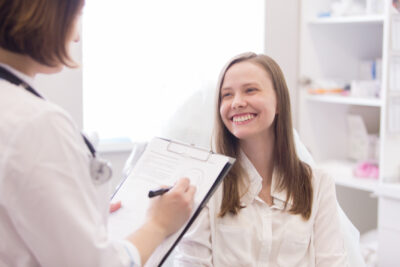 teen patient smiling at her gynecologist and benefiting from continuity of care | University of Colorado OB-GYN | CO