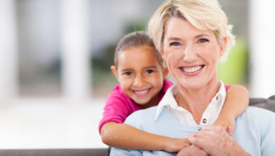 happy little granddaughter and senior grandmother at home