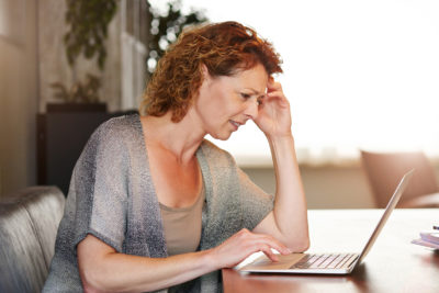 mammogram | thinking woman using laptop | University of Colorado OB-GYN